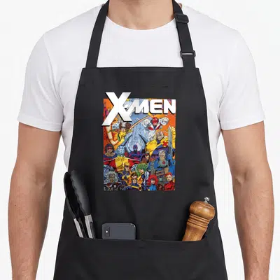 Tablier de cuisine noir avec illustration colorée du logo X-Men et des personnages en pose d'action dynamique.