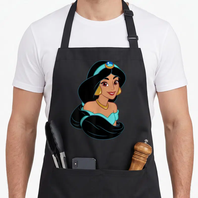 Tablier de cuisine noir avec portrait de Princess Jasmine aux cheveux noirs et coiffe turquoise.