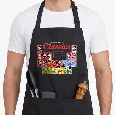 Tablier de cuisine noir avec un tableau périodique coloré illustrant Mickey Mouse et ses amis dans un style scientifique.