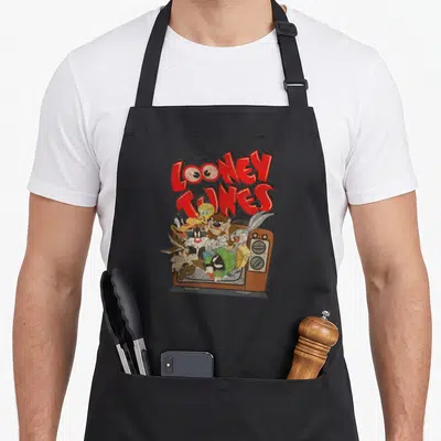 Tablier de cuisine noir avec illustration des Looney Tunes sortant d'un téléviseur orange vintage.