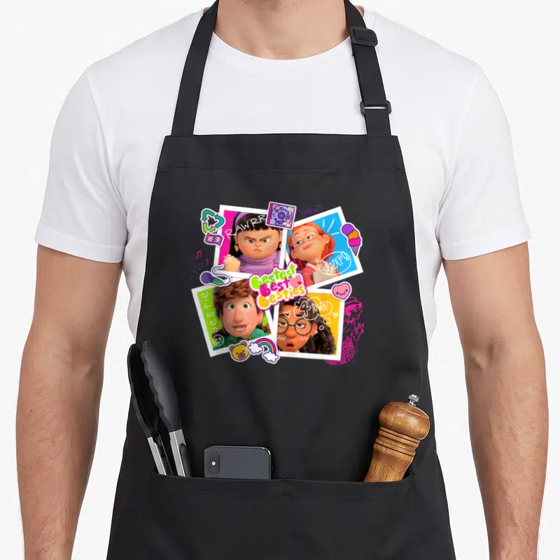 Tablier de cuisine noir avec quatre portraits de personnages animés et le texte Bestest Best Besties entouré de stickers colorés.