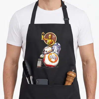 Tablier de cuisine noir avec illustration colorée de C-3PO, R2-D2, BB-8 et d'autres robots de Star Wars.