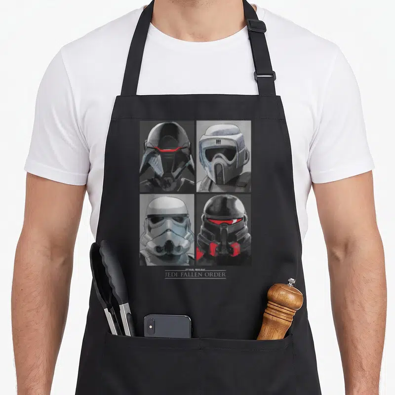 Tablier de cuisine noir avec quatre portraits de casques d'ennemis et le texte Jedi Fallen Order en bas.