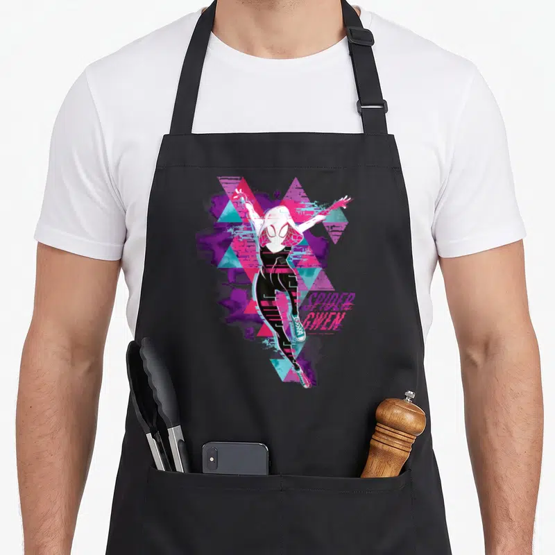 Tablier de cuisine noir avec illustration colorée de Spider-Gwen en pose dynamique entourée de motifs géométriques et de texte stylisé.