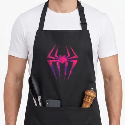 Tablier de cuisine noir avec une araignée stylisée rose et violet aux lignes anguleuses