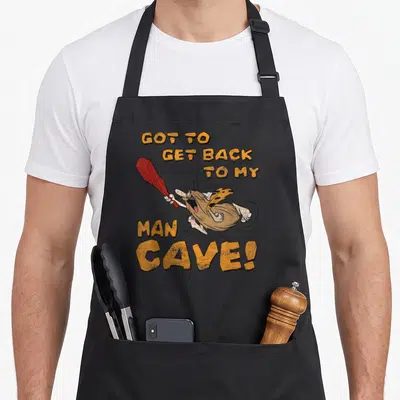 Tablier de cuisine noir avec Captain Caveman tenant une massue rouge et le texte Got to Get Back to My Man Cave.