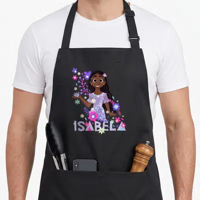 Tablier de cuisine noir avec portrait d'Isabela entourée de fleurs colorées et son nom en lettres stylisées.