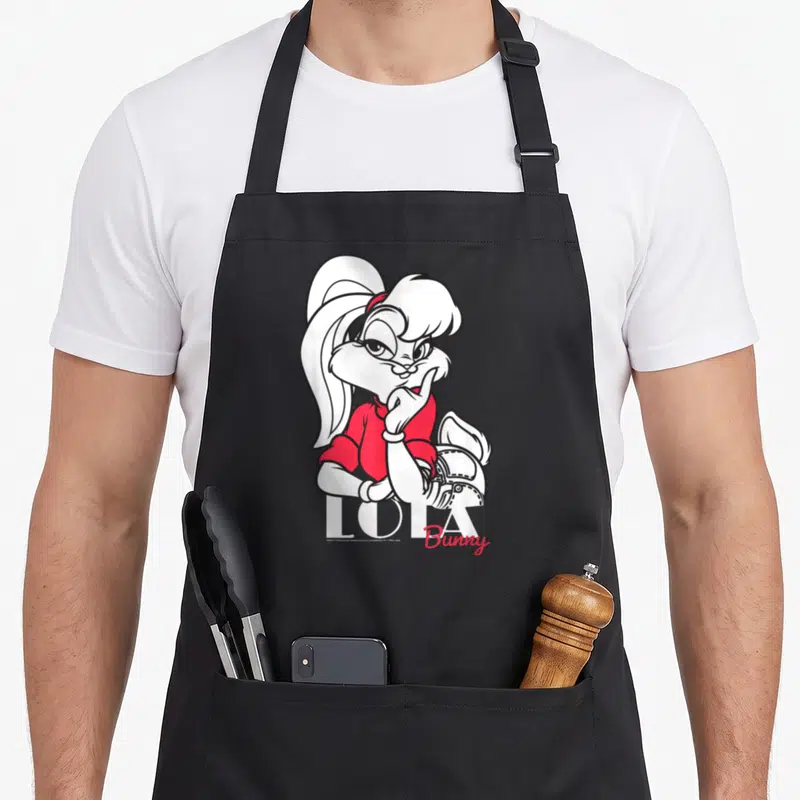 Tablier de cuisine noir avec illustration de Lola Bunny en tenue rouge tenant un casque de moto.