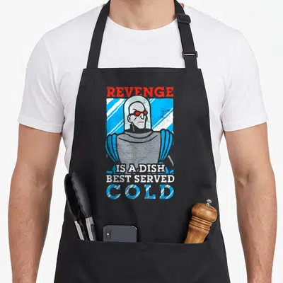 Tablier de cuisine noir avec illustration vintage de Mr. Freeze et texte Revenge is a dish best served cold en bleu et rouge.