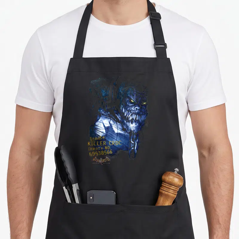 Tablier de cuisine noir avec illustration bleue de Killer Croc, chaînes et texte jaune inmate 09538566 Batman Arkham Asylum