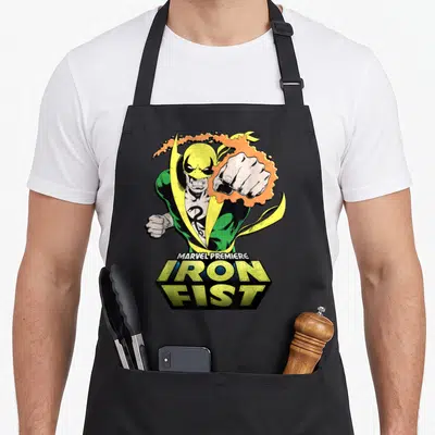 Tablier de cuisine noir avec Iron Fist Marvel Premiere poing jaune et vert style comics