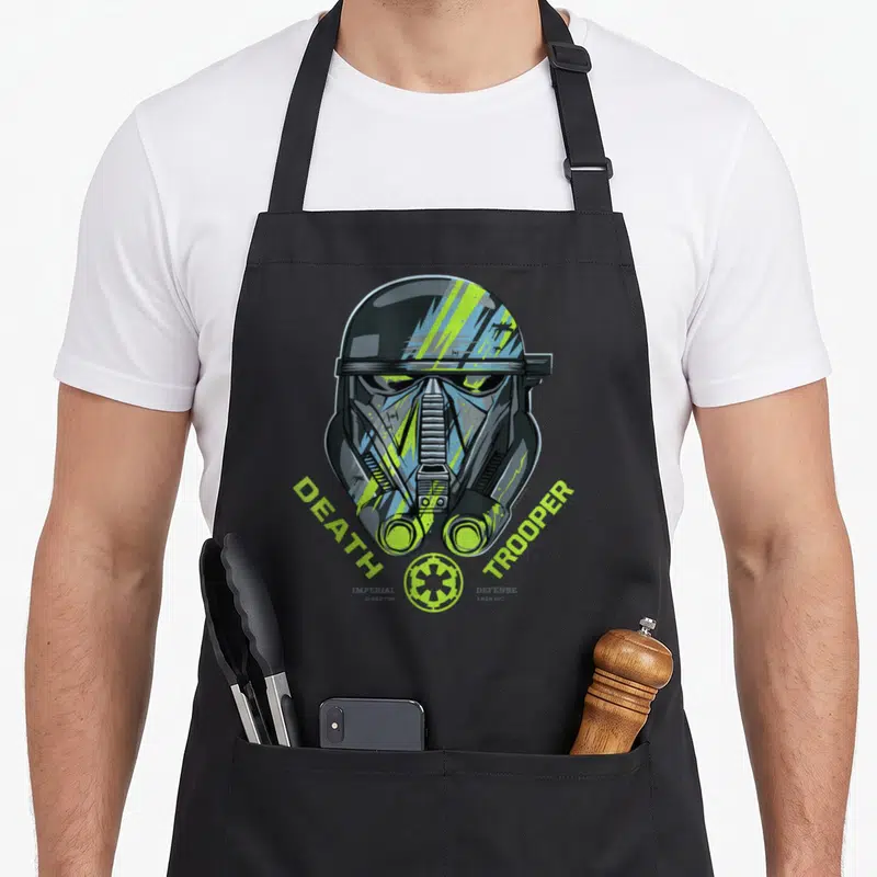 Tablier de cuisine noir avec illustration casque Death Trooper et texte vert fluo Death Trooper Imperial Defense Krennic.