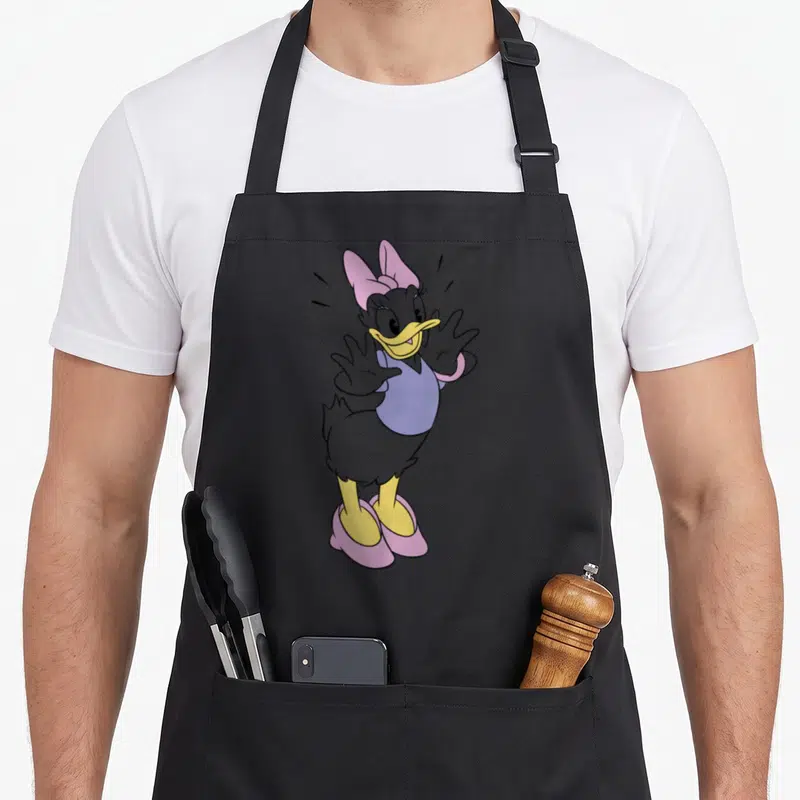 Tablier de cuisine noir avec illustration de Daisy Duck en pose joyeuse aux couleurs vives