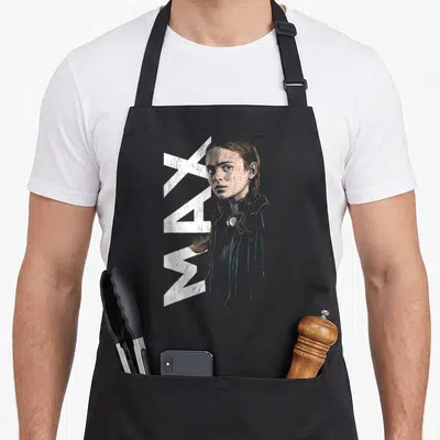 Tablier de cuisine noir avec illustration portrait de Max et texte MAX vertical blanc stylisé.