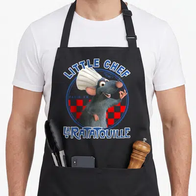 Tablier de cuisine noir avec Remy portant un chapeau de chef et le texte Little Chef La Ratatouille.