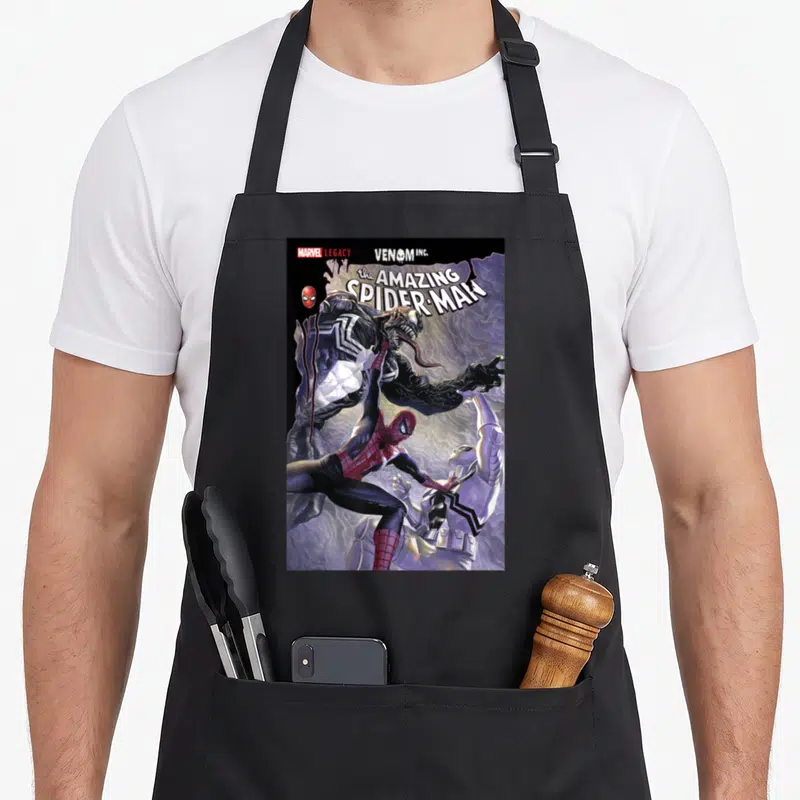 Tablier de cuisine noir avec une illustration de combat entre Spider-Man et Venom sur fond violet.