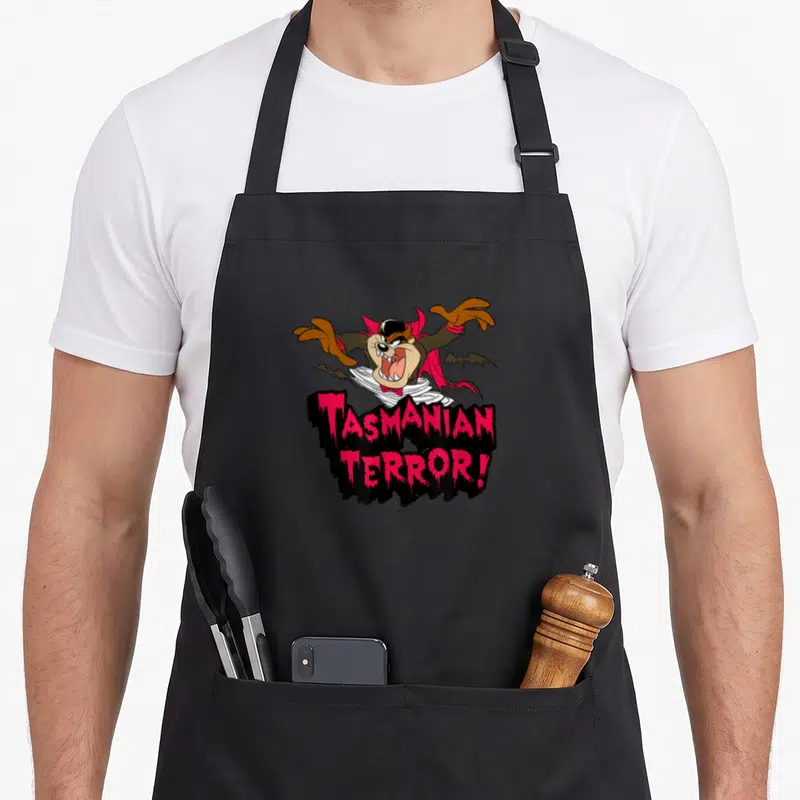 Tablier de cuisine noir avec le Tasmanien vampire et l'inscription Tasmanian Terror. en lettres roses.