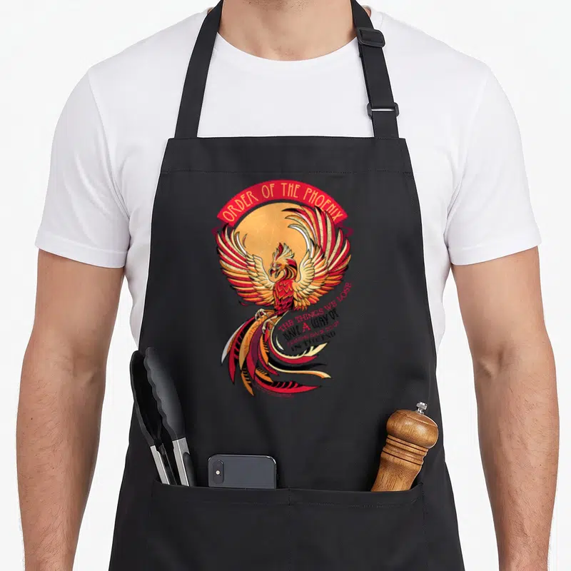 Tablier de cuisine noir avec un phénix aux ailes déployées et le texte Order of the Phoenix en haut.
