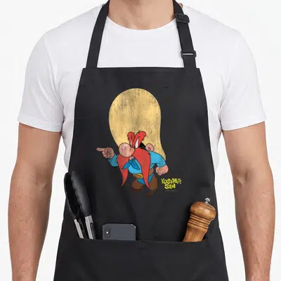 Tablier de cuisine noir avec illustration de Yosemite Sam pointant du doigt et son nom en jaune.