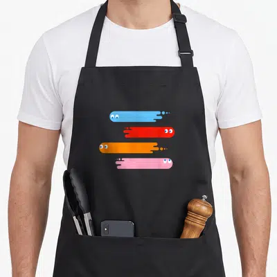 Tablier de cuisine noir avec quatre fantômes stylisés bleu, rouge, orange et rose en traînées horizontales.