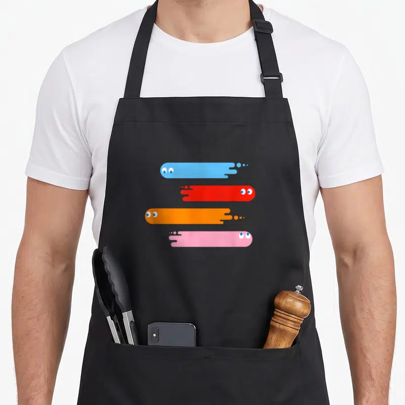 Tablier de cuisine noir avec quatre fantômes stylisés bleu, rouge, orange et rose en traînées horizontales.