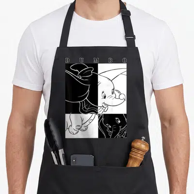Tablier de cuisine noir avec un portrait stylisé de Dumbo divisé en quadrants contrastés et le mot DUMBO en haut.