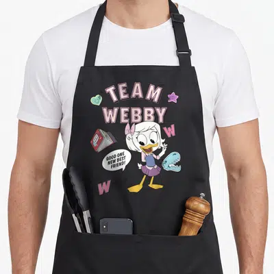 Tablier de cuisine noir avec l'illustration colorée de Webby et le texte Team Webby en rose.