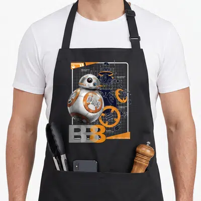 Tablier de cuisine noir avec illustration technique colorée du robot BB-8 et ses pièces détachées sur fond quadrillé.