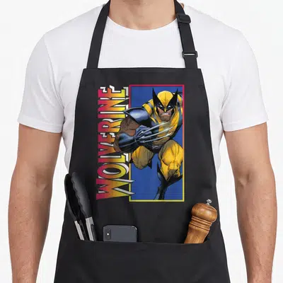 Tablier de cuisine noir avec une illustration de Wolverine en action et son nom en lettres colorées sur le côté gauche.
