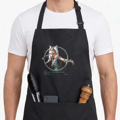 Tablier de cuisine noir avec portrait stylisé d'Ahsoka Tano et texte Just Who I Am dans un cercle bleu.