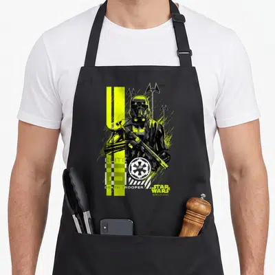 Tablier de cuisine noir avec illustration Death Trooper Elite Star Wars Rogue One aux couleurs jaune vif et vert lime.