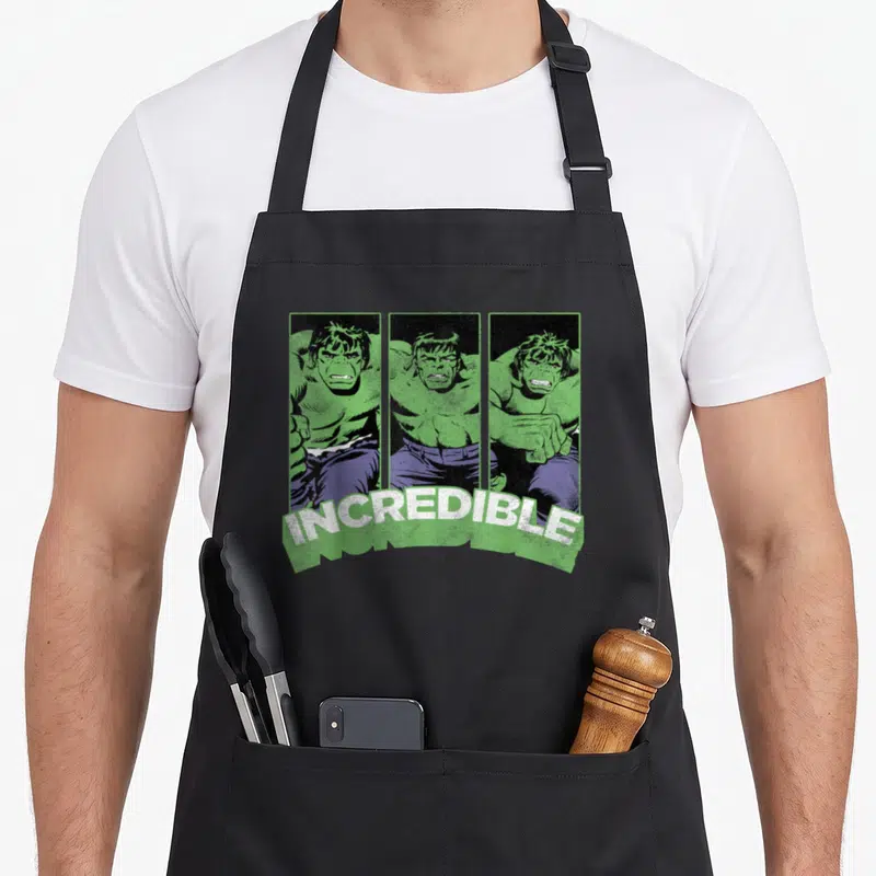 Tablier de cuisine noir avec illustration triptyque du Hulk vert et texte INCREDIBLE en blanc.