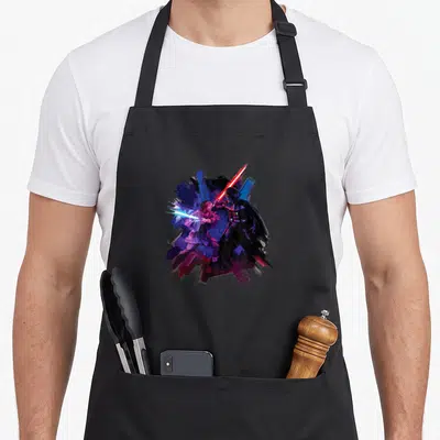 Tablier de cuisine noir avec illustration colorée d'Obi-Wan Kenobi et Darth Vader en duel au sabre laser.