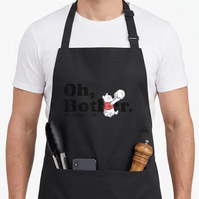 Tablier de cuisine noir avec Winnie l'ourson en dessin au trait tenant un pot et le texte Oh Bother.