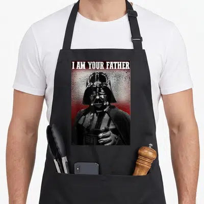 Tablier de cuisine noir avec Darth Vader pointant le doigt et le texte I AM YOUR FATHER en haut.