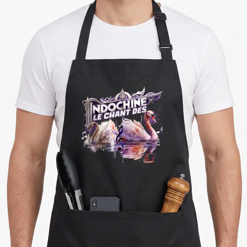 Tablier de cuisine noir avec deux cygnes nageant sous le texte Le Chant des Indochine et une clé de sol multicolore.