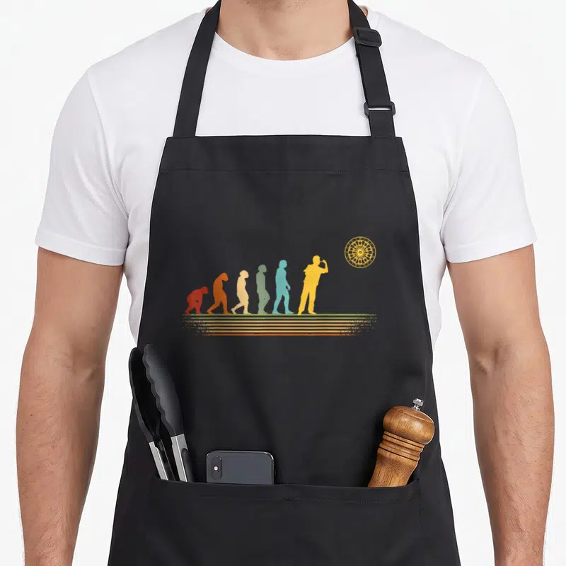 Tablier de cuisine noir avec évolution humaine en silhouettes colorées menant à un joueur de fléchettes et une cible jaune.