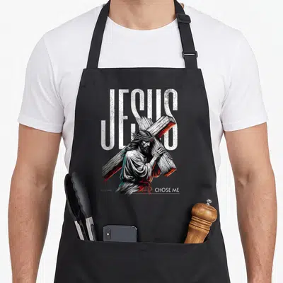 Tablier de cuisine noir avec une illustration de Jésus portant la croix et le texte Jésus Chose Me en blanc.