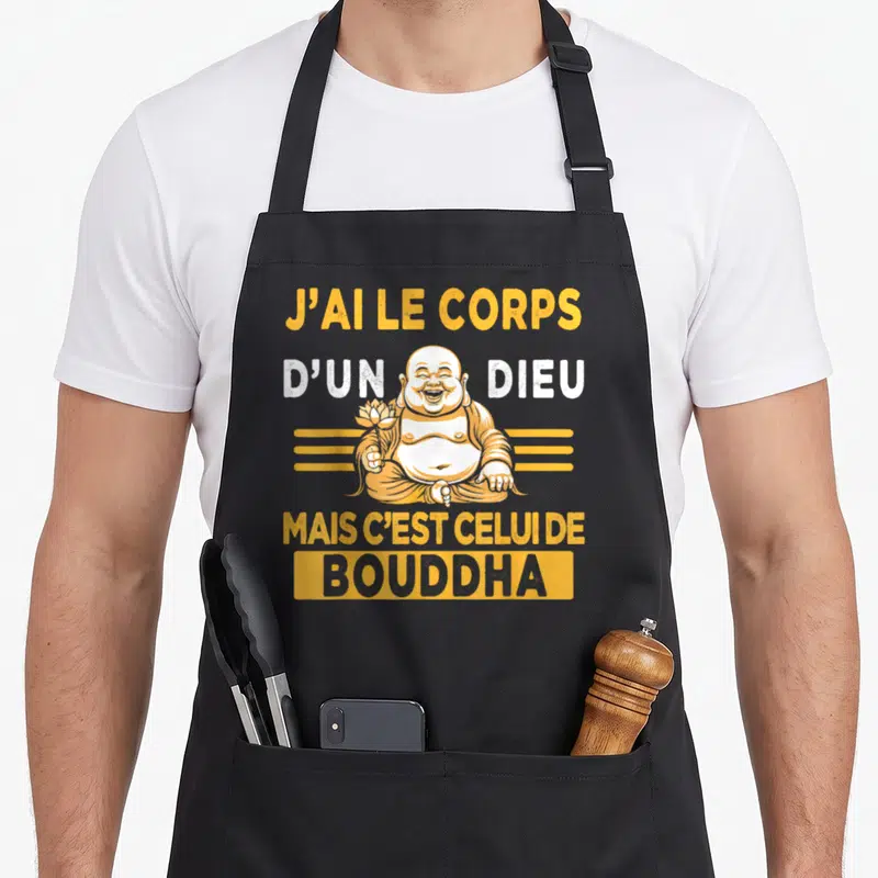 Tablier de cuisine noir avec une illustration du Bouddha riant tenant une fleur de lotus et un texte humoristique en orange et blanc.