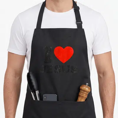 Tablier de cuisine noir avec inscription I Love Jesus Christ et un grand cœur rouge au centre du motif imprimé.