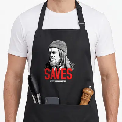 Tablier de cuisine noir avec portrait Negan et le mot SAVES en lettres rouges vives.