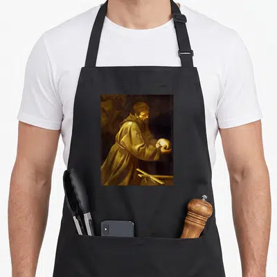 Tablier de cuisine noir avec reproduction du tableau Saint François en prière par Caravage, montrant le saint tenant un crâne.