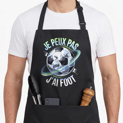 Tablier de cuisine noir avec un ballon de foot et l'inscription Je peux pas j'ai foot en bleu et vert.
