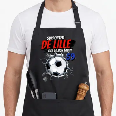 Tablier de cuisine noir avec illustration balle de football brisant un mur et texte Supporter de Lille 59