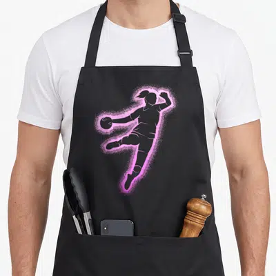 Tablier de cuisine noir avec silhouette femme handballeuse sautant et tenant un ballon, contour rose effet poudré.