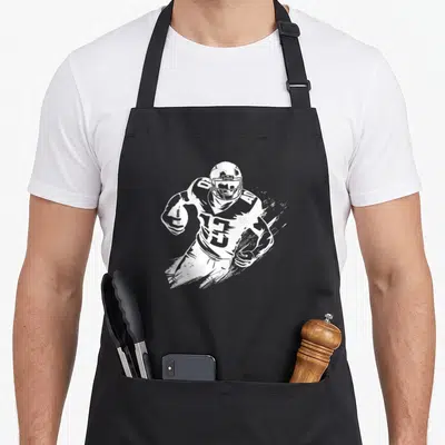 Tablier de cuisine noir avec illustration blanche d'un joueur de football américain Quarterbacks portant le numéro 13 et tenant la balle.