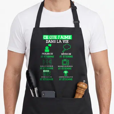 Tablier de cuisine noir avec des icônes vertes et blanches sur le thème du football et de St Étienne.