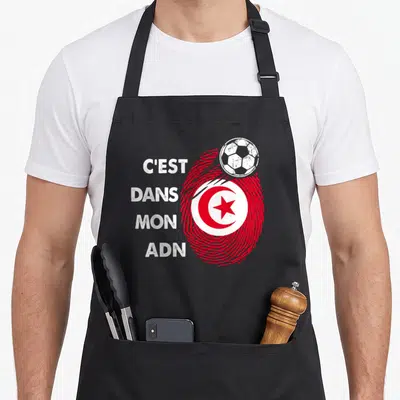 Tablier de cuisine noir avec empreinte digitale rouge et texte blanc C'est dans mon ADN