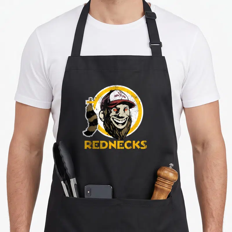 Tablier de cuisine noir avec illustration d'un homme barbu au chapeau et la mention Rednecks en lettres jaunes.