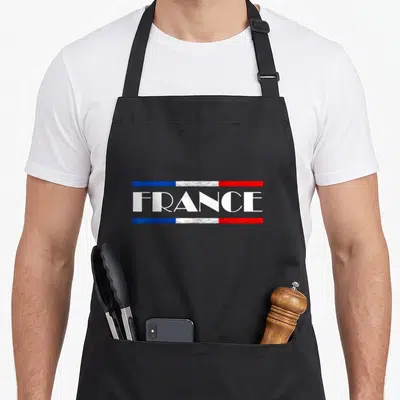 Tablier de cuisine noir avec inscription FRANCE et bandes tricolores bleue blanche rouge texturées.